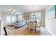 Light-filled dining area with a four-person table and access to the living room at 144 Puffin Dr. # 2-E, Pawleys Island, SC 29585