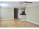 Spacious living area with hardwood floors and modern light fixture at 144 Puffin Dr. # 2-E, Pawleys Island, SC 29585