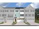 Three-story townhome with light gray and white siding, two-car garage, and landscaping at Tbd Jazz Ct. # Tbd, Myrtle Beach, SC 29572