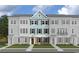 Three-story townhome with light teal siding and brick accents at Tbd Atlantic Breeze St. # Tbd, Myrtle Beach, SC 29572