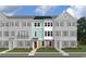 Three-story townhome with light teal siding and brick accents at Tbd Atlantic Breeze St. # Tbd, Myrtle Beach, SC 29572
