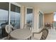 Balcony with table and chairs and partial ocean view at 1321 S Ocean Blvd. # 606, North Myrtle Beach, SC 29582