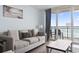 Living room with ocean view and comfy seating at 1321 S Ocean Blvd. # 606, North Myrtle Beach, SC 29582