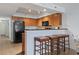 Kitchen with breakfast bar and three barstools, offering extra seating at 1321 S Ocean Blvd. # 606, North Myrtle Beach, SC 29582