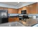 Modern kitchen with wood cabinets and granite countertops at 1321 S Ocean Blvd. # 606, North Myrtle Beach, SC 29582