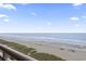 Panoramic view of a sandy beach and ocean waves at 1321 S Ocean Blvd. # 606, North Myrtle Beach, SC 29582