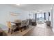 Dining area with four chairs and a view of the ocean from the living room at 1321 S Ocean Blvd. # 606, North Myrtle Beach, SC 29582