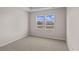 Bright bedroom with two windows and neutral decor at 3058 Deerberry Place, Longs, SC 29568