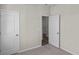 Simple bedroom with open doorway, neutral walls, and carpet flooring at 3058 Deerberry Place, Longs, SC 29568