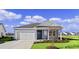 Charming one-story home with light blue siding, a white door, and a two-car garage at 3058 Deerberry Place, Longs, SC 29568