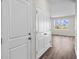 Bright hallway with white doors, wood-look floors, and access to other rooms at 3058 Deerberry Place, Longs, SC 29568