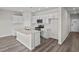 Modern kitchen with island, stainless steel appliances, and light cabinets at 3058 Deerberry Place, Longs, SC 29568