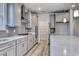 Modern kitchen with gray cabinets, quartz countertops, stainless steel appliances, and walk-in pantry at 1617 Littleleaf Loop, North Myrtle Beach, SC 29582