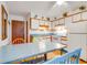 Bright kitchen with white cabinets and a dining area at 1582 S Waccamaw Dr. # 10, Murrells Inlet, SC 29576