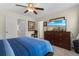 Spacious bedroom with a large TV, dresser, and access to other rooms at 444 Papyrus Circle # 444, Little River, SC 29566