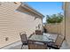 Small patio with table and chairs, adjacent to home exterior at 444 Papyrus Circle # 444, Little River, SC 29566