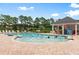 Community pool with a shallow end and a shaded seating area at 444 Papyrus Circle # 444, Little River, SC 29566