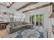 Living area with L-shaped sofa, exposed beams, and view into kitchen at 2056 Summer Rose Ln., Myrtle Beach, SC 29579