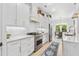 Modern kitchen with white cabinets, a large island, and stainless steel appliances at 2056 Summer Rose Ln., Myrtle Beach, SC 29579