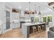 Bright kitchen boasting white cabinets, a statement hood, and a large island at 2056 Summer Rose Ln., Myrtle Beach, SC 29579