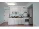 White kitchen cabinets, granite countertops, and stainless steel appliances at 14290 Ocean Hwy. # 208, Pawleys Island, SC 29585