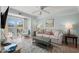 Living room features a sofa, coffee table, and sliding doors leading to a balcony at 14290 Ocean Hwy. # 208, Pawleys Island, SC 29585