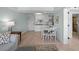 Living room and kitchen with light flooring and a light blue wall at 14290 Ocean Hwy. # 208, Pawleys Island, SC 29585