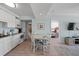 Open concept dining area with white table and chairs at 14290 Ocean Hwy. # 208, Pawleys Island, SC 29585