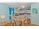 Well-equipped kitchen with white cabinets and a dining area at 6001 - 1819 S Kings Hwy., Myrtle Beach, SC 29575