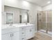 Bathroom boasts double vanity, a large mirror, and a glass shower at 616 Blackthorne Circle Nw, Calabash, NC 28467