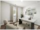 Home office featuring hardwood floors, large window, and built-in workspace at 616 Blackthorne Circle Nw, Calabash, NC 28467