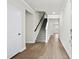 Bright and spacious entryway with hardwood floors and a staircase leading to the upper level at 616 Blackthorne Circle Nw, Calabash, NC 28467