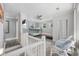 Upstairs bedroom with a bunk bed, and two white chairs near the balcony at 605 36Th Ave. S, North Myrtle Beach, SC 29582