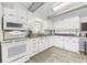 White kitchen with granite countertops and stainless steel appliances at 605 36Th Ave. S, North Myrtle Beach, SC 29582
