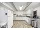 White kitchen with granite countertops and stainless steel appliances at 605 36Th Ave. S, North Myrtle Beach, SC 29582
