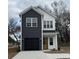 Two-story home with dark siding, white accents, and a modern design at 214 26Th Ave. S, Myrtle Beach, SC 29577