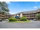 Exterior view of a two-story building with parking and landscaping at 410 Melrose Pl. # 309, Myrtle Beach, SC 29572