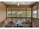 Screened balcony overlooking water, with table and chairs at 410 Melrose Pl. # 309, Myrtle Beach, SC 29572
