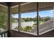 View from a screened porch overlooking a tranquil lake at 410 Melrose Pl. # 309, Myrtle Beach, SC 29572