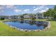 Pond reflecting building with landscaping at 8862 Cloister Dr. # F, Myrtle Beach, SC 29575