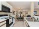 Open kitchen with breakfast nook, features a glass table and teal chairs at 8862 Cloister Dr. # F, Myrtle Beach, SC 29575