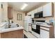 Bright kitchen features white cabinets, stainless steel appliances, and double sink at 8862 Cloister Dr. # F, Myrtle Beach, SC 29575