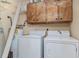 Functional laundry room with washer, dryer, and upper cabinets at 8862 Cloister Dr. # F, Myrtle Beach, SC 29575