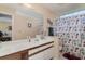 Clean bathroom with single sink vanity, shower/tub combo, and seashell-themed shower curtain at 8862 Cloister Dr. # F, Myrtle Beach, SC 29575