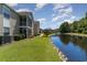 Building beside a pond with green lawn at 8862 Cloister Dr. # F, Myrtle Beach, SC 29575