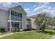 Tan siding condo building with a screened porch and landscaping at 8862 Cloister Dr. # F, Myrtle Beach, SC 29575