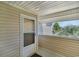 Screened porch with exterior door and view of the neighborhood at 8862 Cloister Dr. # F, Myrtle Beach, SC 29575