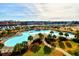 Resort-style pool with surrounding palm trees at 5801 Oyster Catcher Dr. # 434, North Myrtle Beach, SC 29582
