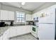 Well-equipped kitchen with granite countertops and white cabinets at 5801 Oyster Catcher Dr. # 434, North Myrtle Beach, SC 29582