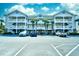 Three-story building with balconies and ample parking at 5801 Oyster Catcher Dr. # 434, North Myrtle Beach, SC 29582